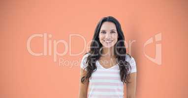 Young woman smiling over peach background