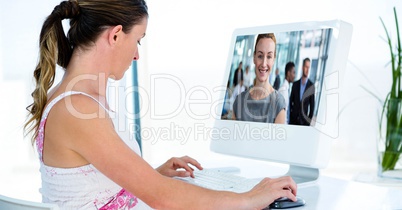 Businesswoman video conferencing with colleagues on computer