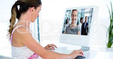 Businesswoman video conferencing with colleagues on computer
