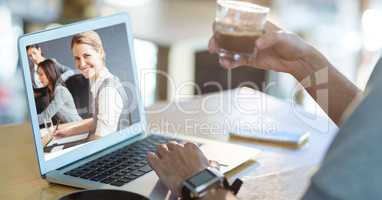Cropped image of person video conferencing on laptop while having coffee
