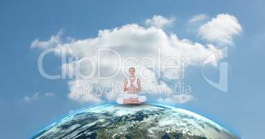 Fit woman meditating on earth against sky