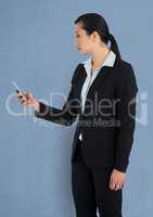 Businesswoman holding mobile phone over blue background
