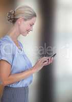 Side view of smiling businesswoman using smart phone