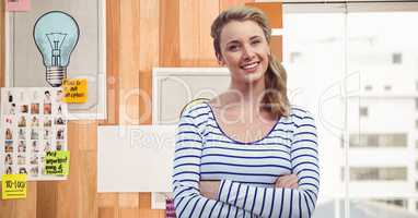 Businesswoman with arms crossed against wall