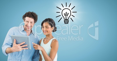 Man and woman with tablet and lightbulb doodle with flare against blue background Man and woman with tablet and lightbulb doodle with flare against blue background