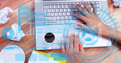 Digital composite image of hands using laptop on wooden table
