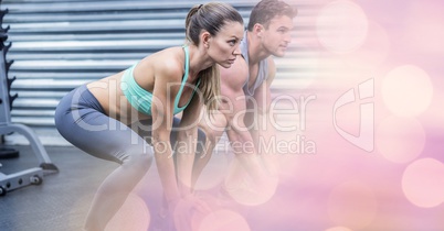 Woman and man exercising in gym