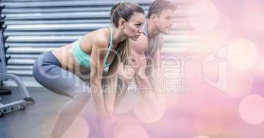 Woman and man exercising in gym