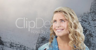 Smiling woman against snowcapped mountains