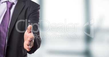 Midsection of businessman offering handshake