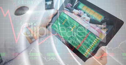 Hands holding digital tablet displaying data with overlay