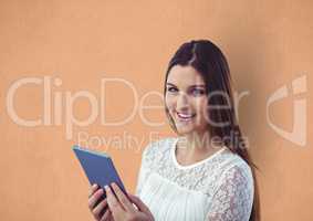 Happy young woman holding digital tablet