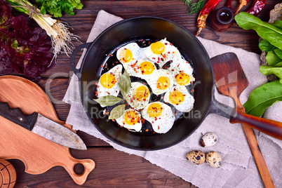 Fried quail eggs in a frying pan