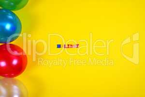 Abstract yellow background with balloons and inscription holiday