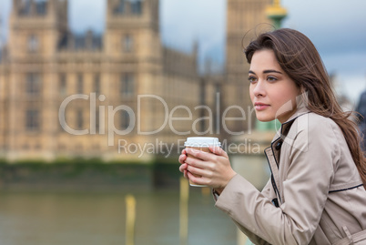 Sad Thoughtful Woman Drinking Coffee in London by Big Ben