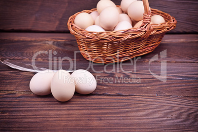 Chicken eggs in shell and in a wicker basket