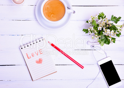 cup of coffee and a smartphone with headphones