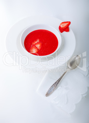 Strawberry soup with white napkin on a table.