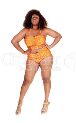 African woman in bikini hands on hip.