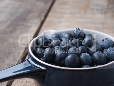 Organic blueberries in a rustic bowl