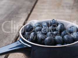 Organic blueberries in a rustic bowl