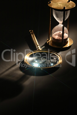 Hourglass And Magnifying Glass