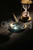 Hourglass And Magnifying Glass