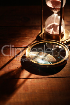 Hourglass And Magnifying Glass