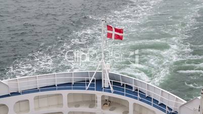 Danish flag fluttering in the wind on the ship