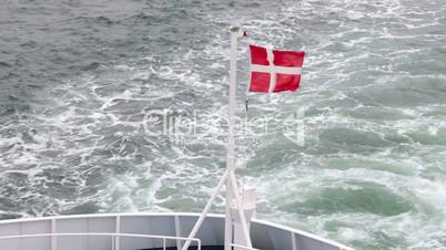 Danish flag fluttering in the wind on the ship