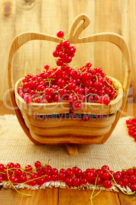 fresh red currant on the wooden vase