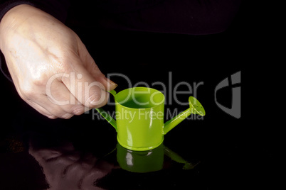 Hand with watering can