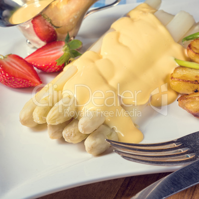 Asparagus , hollandaise sauce and baked potatoes