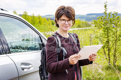 Woman with tablet pc in nature