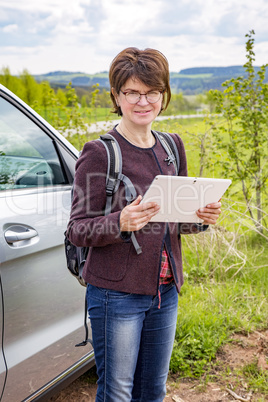 Woman with tablet pc in nature