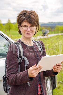 Woman with tablet pc in nature