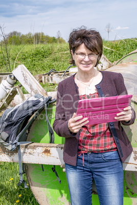 Woman with tablet pc in nature