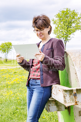 Woman with tablet pc in nature