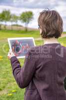 Woman with tablet pc in nature