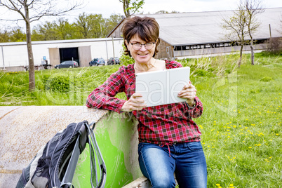 Woman with tablet pc in nature