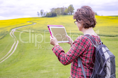 Woman with tablet pc in nature