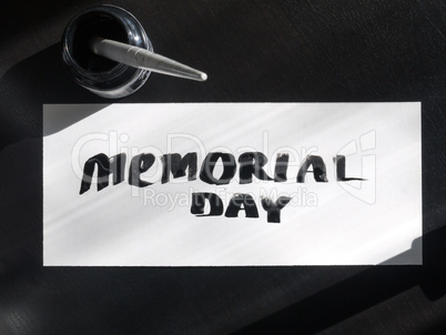 Memorial day calligraphy and lettering post card with inkstand. Top view and sunlight.