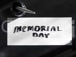 Memorial day calligraphy and lettering post card with inkstand. Top view and sunlight.