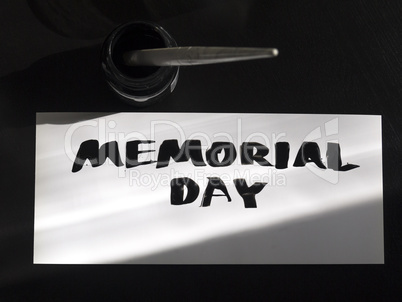 Memorial day calligraphy and lettering post card with inkstand. Top view and sunlight shadow.