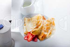 Crepes with strawberries and coffee