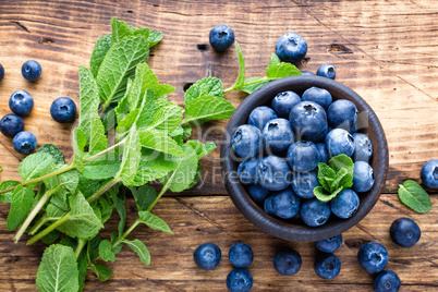 Fresh blueberries in bowl on wooden table