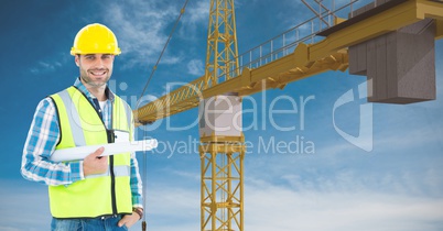 Architect holding blue prints against crane