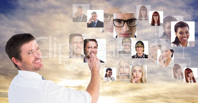 Portrait of businessman using futuristic screen with flying photographs