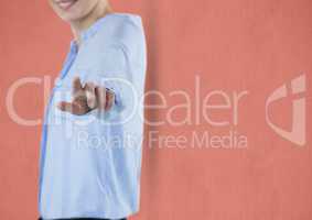 Midsection of businesswoman touching imaginary screen against colored background