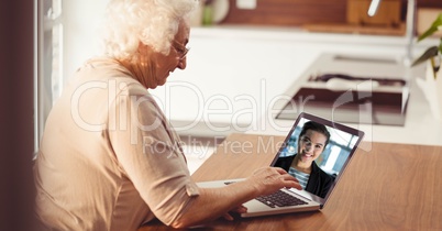 Senior woman video conferencing on laptop